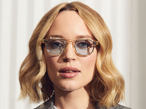 Model is wearing The CLIPTOSH in Gold in size 46 with Bel Air Blue Tinted Lenses