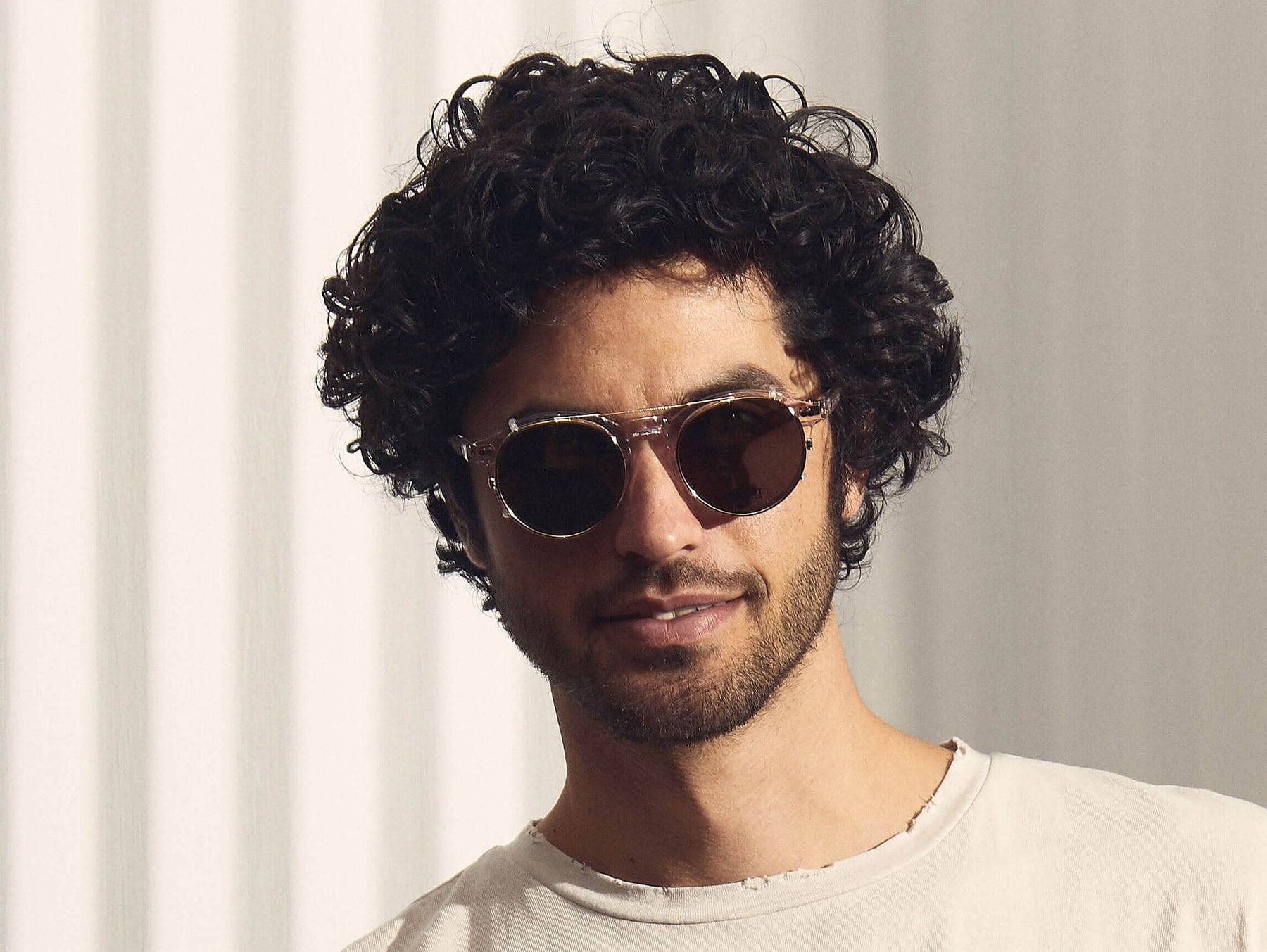 Model is wearing The CLIPZEN in Gold in size 49 with G-15 Lenses