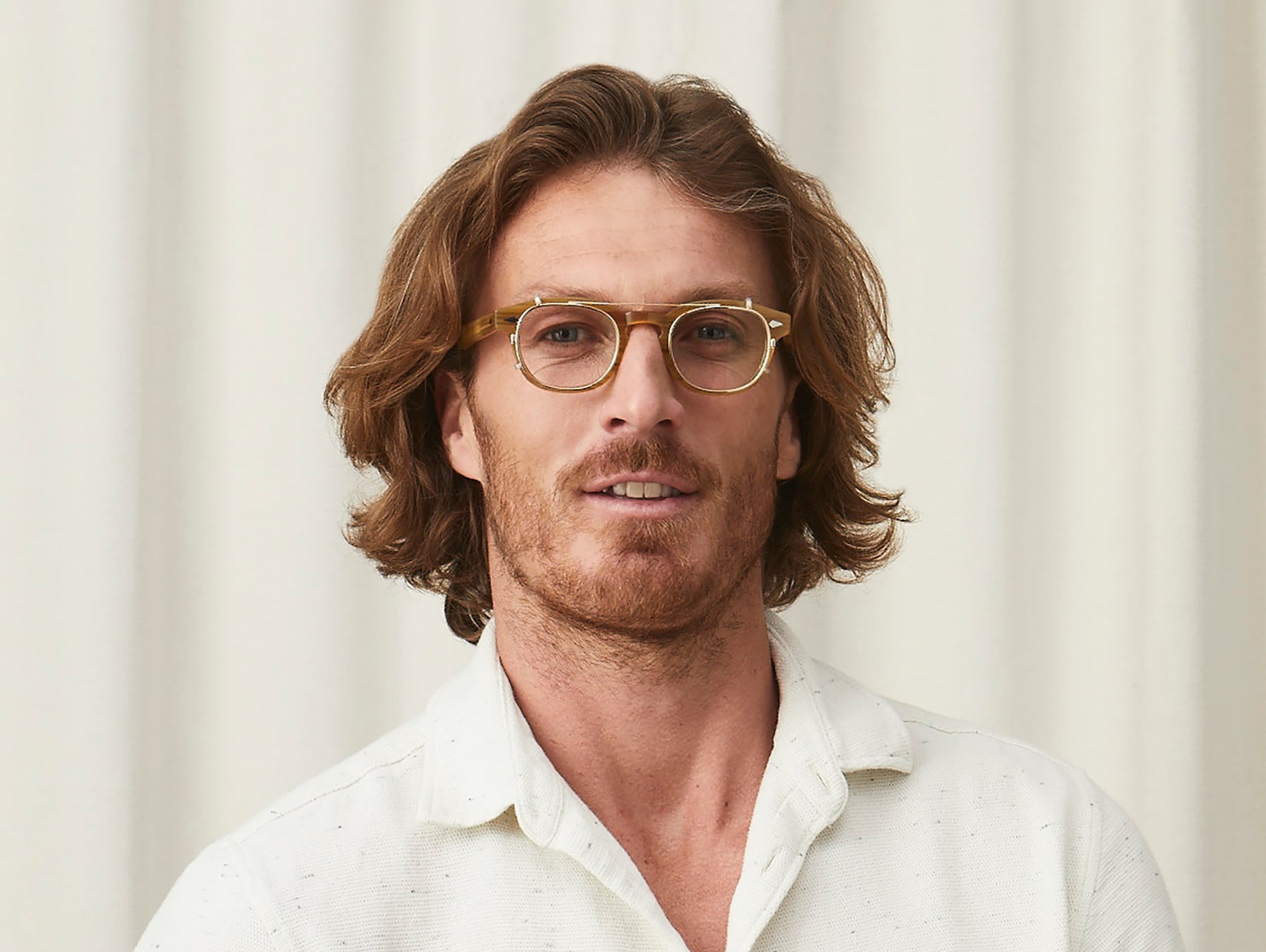 Model is wearing The CLIPTOSH in Gold in size 46 with Blue Protect Lenses