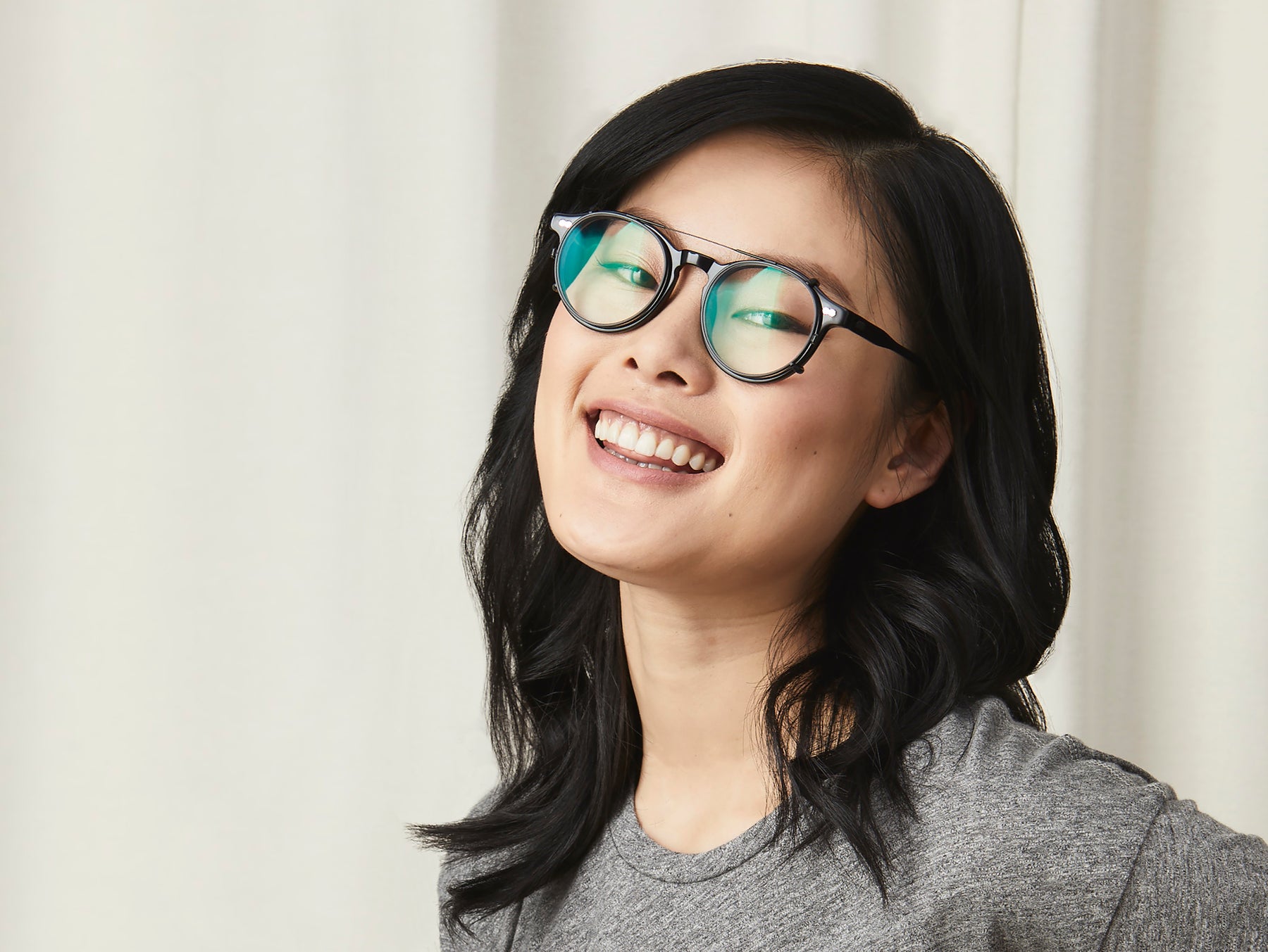 Model is wearing The CLIPZEN in Matte Black in size 49 with Blue Protect Lenses