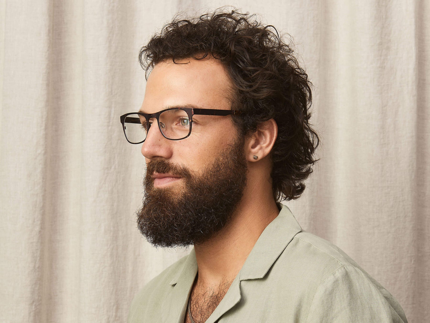 The Model is wearing The NEBB-T in Tortoise/Pine in size 51 with Blue Light Filter Lenses