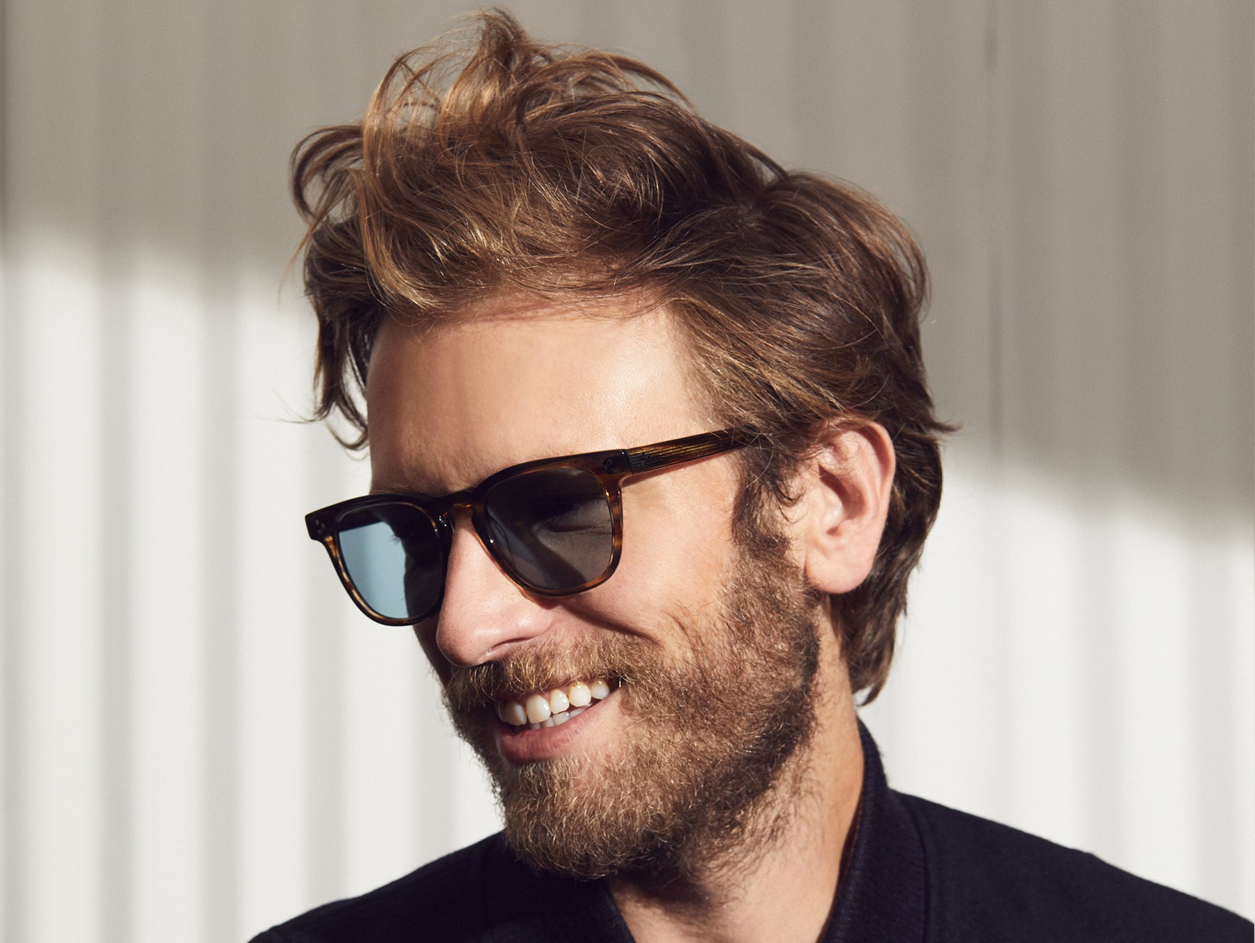 Model is wearing The DUDEL SUN in Bark in size 51 with Blue Glass Lenses