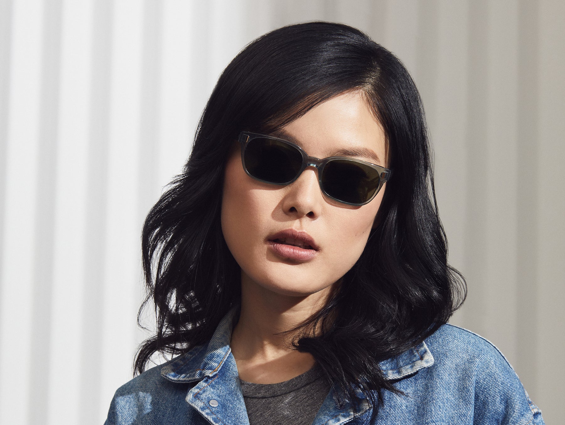 Model is wearing The EMIS SUN in Blue Smoke with G-15 Glass Lenses