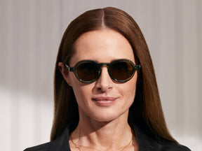 Model is wearing The FOYGEL SUN in Pine in size 46 with Green Tinted Lenses