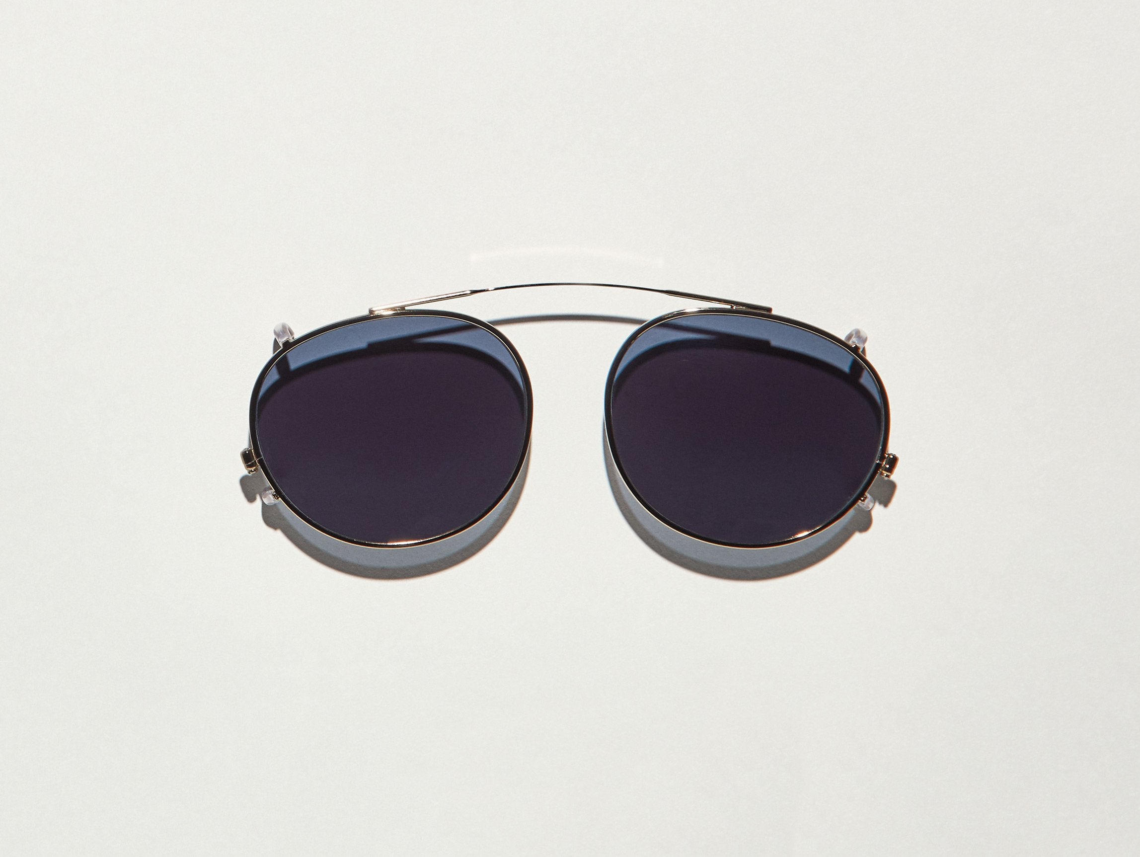 The FRANKIE CLIP in Brass with Grey Lenses