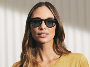 Model is wearing The GELT SUN in Tortoise in size 49 with Blue Glass Lenses