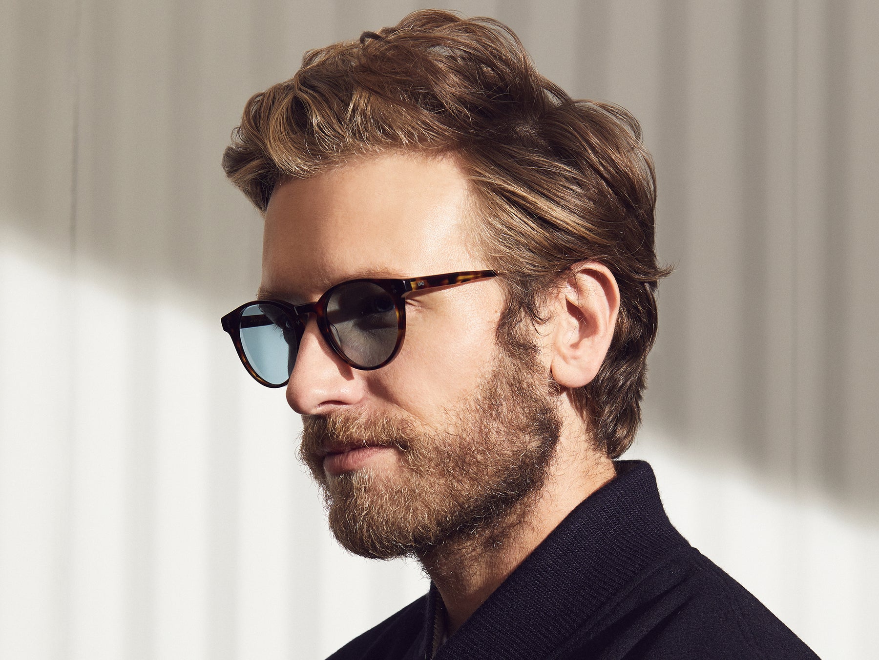 Model is wearing The GOLDA SUN in Spot Tortoise/Gold in size 49 with Blue Glass Lenses