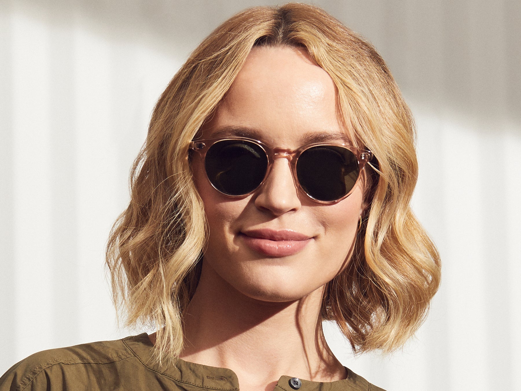 Model is wearing The GOLDA SUN in Burnt Rose in size 49 with G-15 Glass Lenses