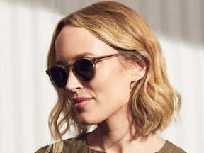 Model is wearing The GOLDA SUN in Burnt Rose in size 49 with G-15 Glass Lenses