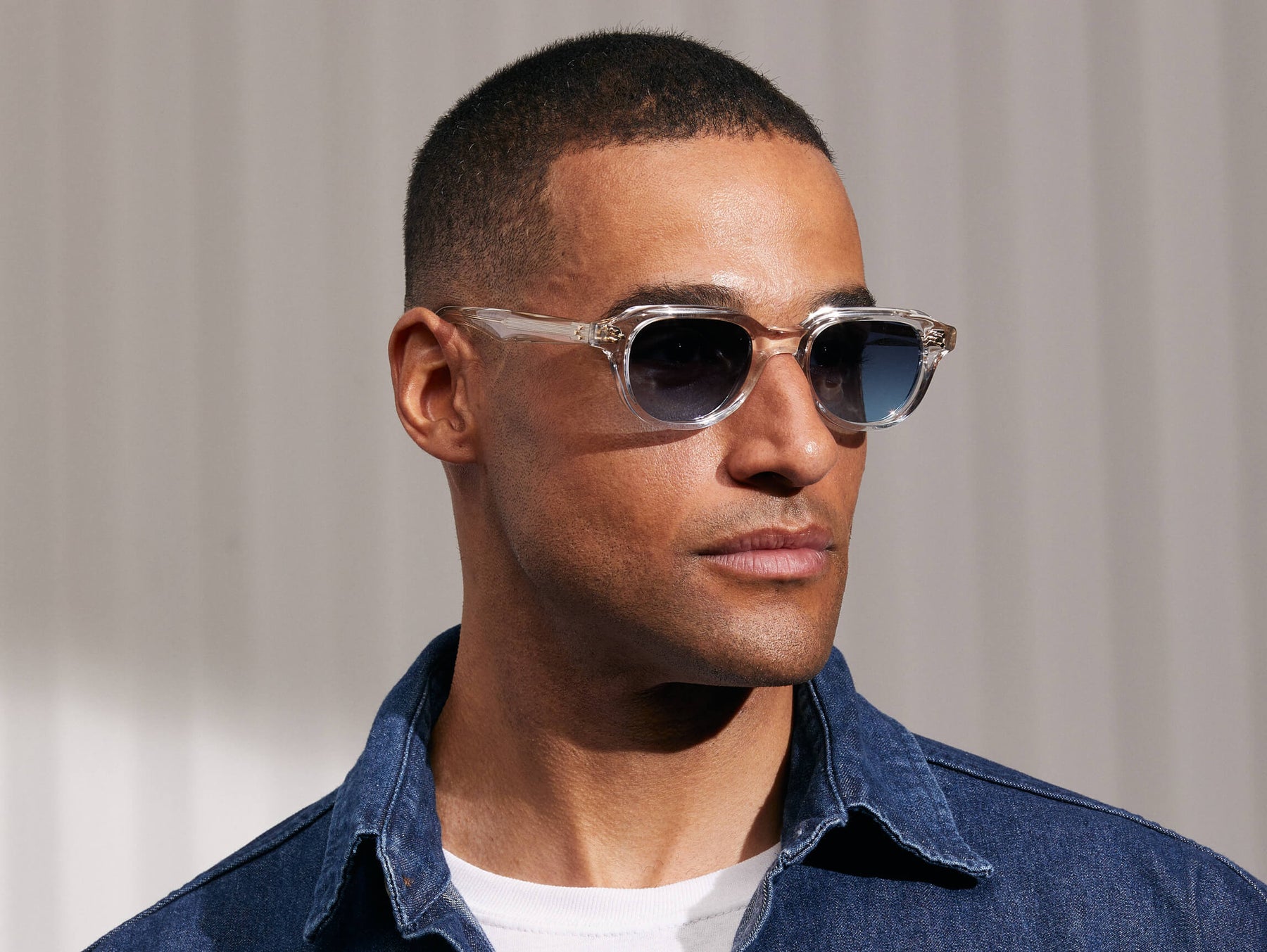 Model is wearing The GOOLAH SUN in Crystal in size 50 with Denim Blue Tinted Lenses