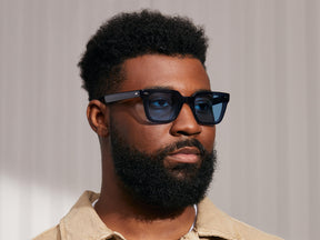 Model is wearing The GROBER SUN in Navy in size 48 with Celebrity Blue Tinted Lenses