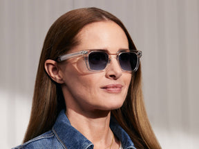Model is wearing The GROBER SUN in Crystal in size 48 with Denim Blue Tinted Lenses