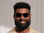 Model is wearing The KASH SUN in Tortoise/Gold in size 50 with G-15 Glass Lenses