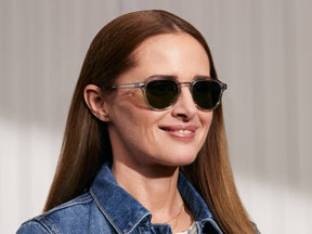 Model is wearing The KASH SUN in Light Grey/Silver in size 50 with Calibar Green Glass Lenses