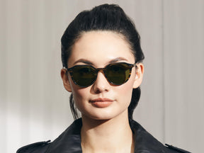 Model is wearing The KITZEL SUN in Brown Bamboo in size 50 with Calibar Green Glass Lenses