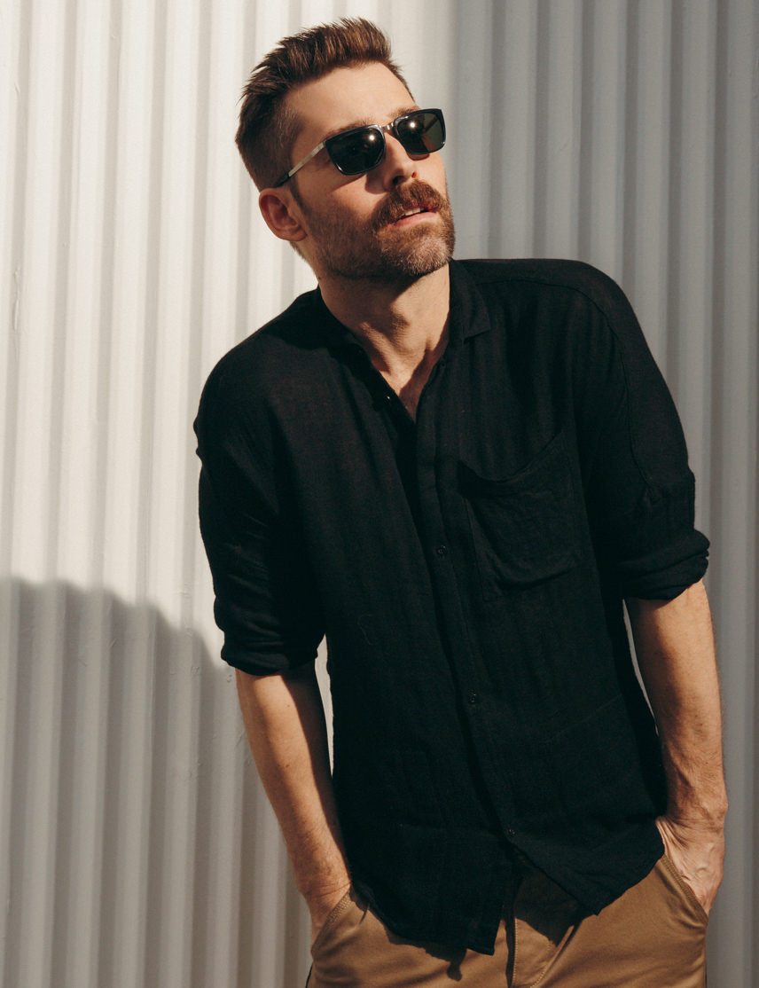 Model is wearing The KLUG SUN in Black/Silver in size 52 with G-15 Glass Lenses