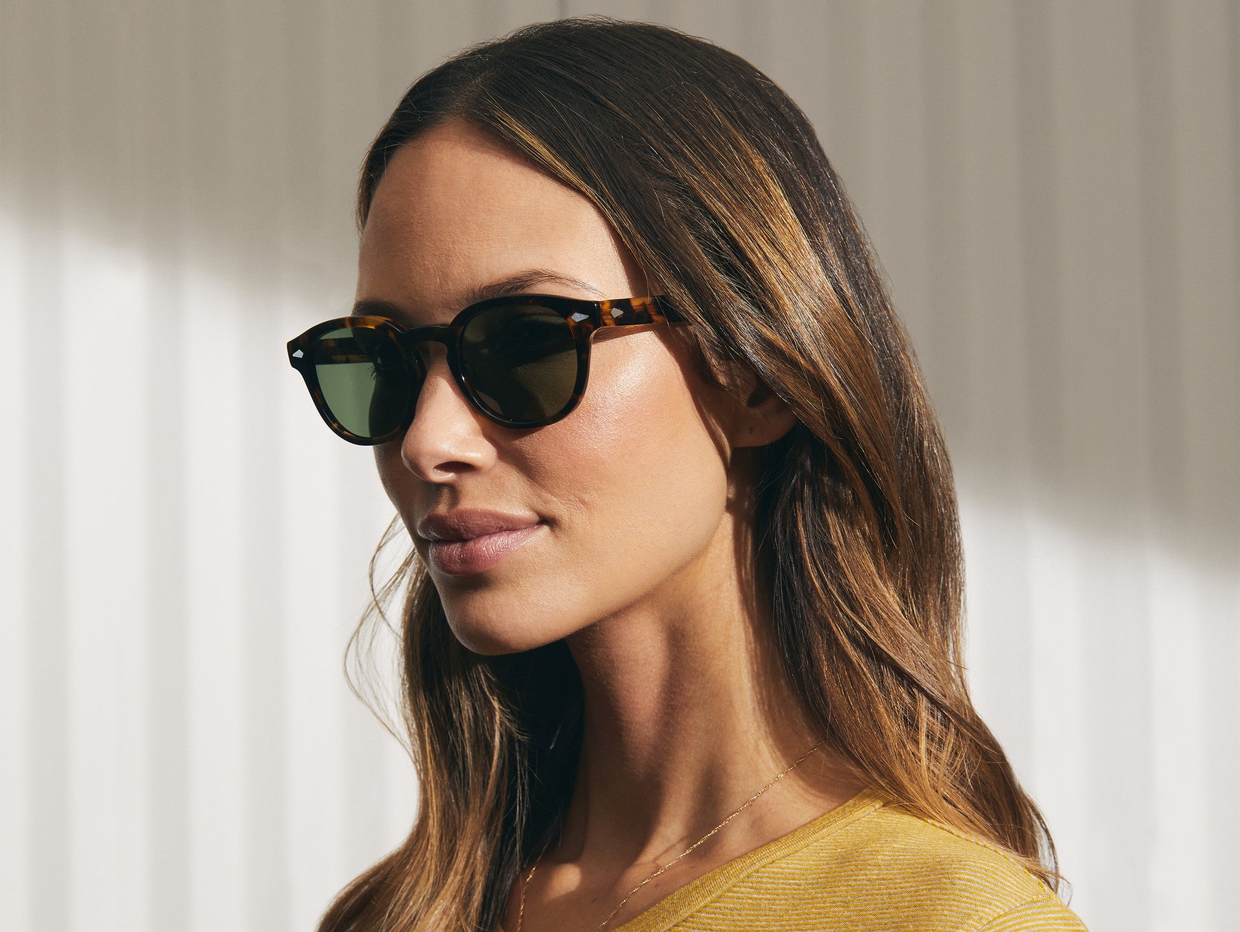 Model is wearing The LEMTOSH SUN in Classic Havana in size 49 with G-15 Glass Lenses