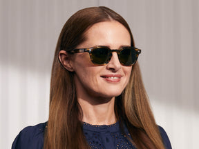 Model is wearing The LEMTOSH SUN in Bamboo in size 49 with Calibar Green Glass Lenses