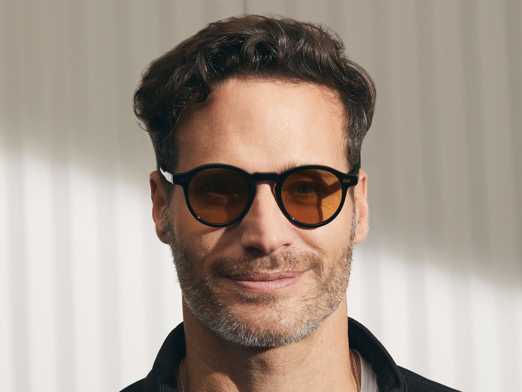 Model is wearing The MILTZEN in Black in size 46 with Amber Tinted Lenses