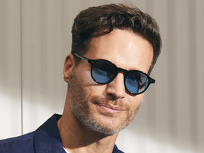 Model is wearing The MILTZEN in Black in size 46 with Celebrity Blue Tinted Lenses