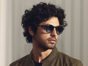 Model is wearing The MILTZEN in Black in size 49 with Denim Blue Tinted Lenses