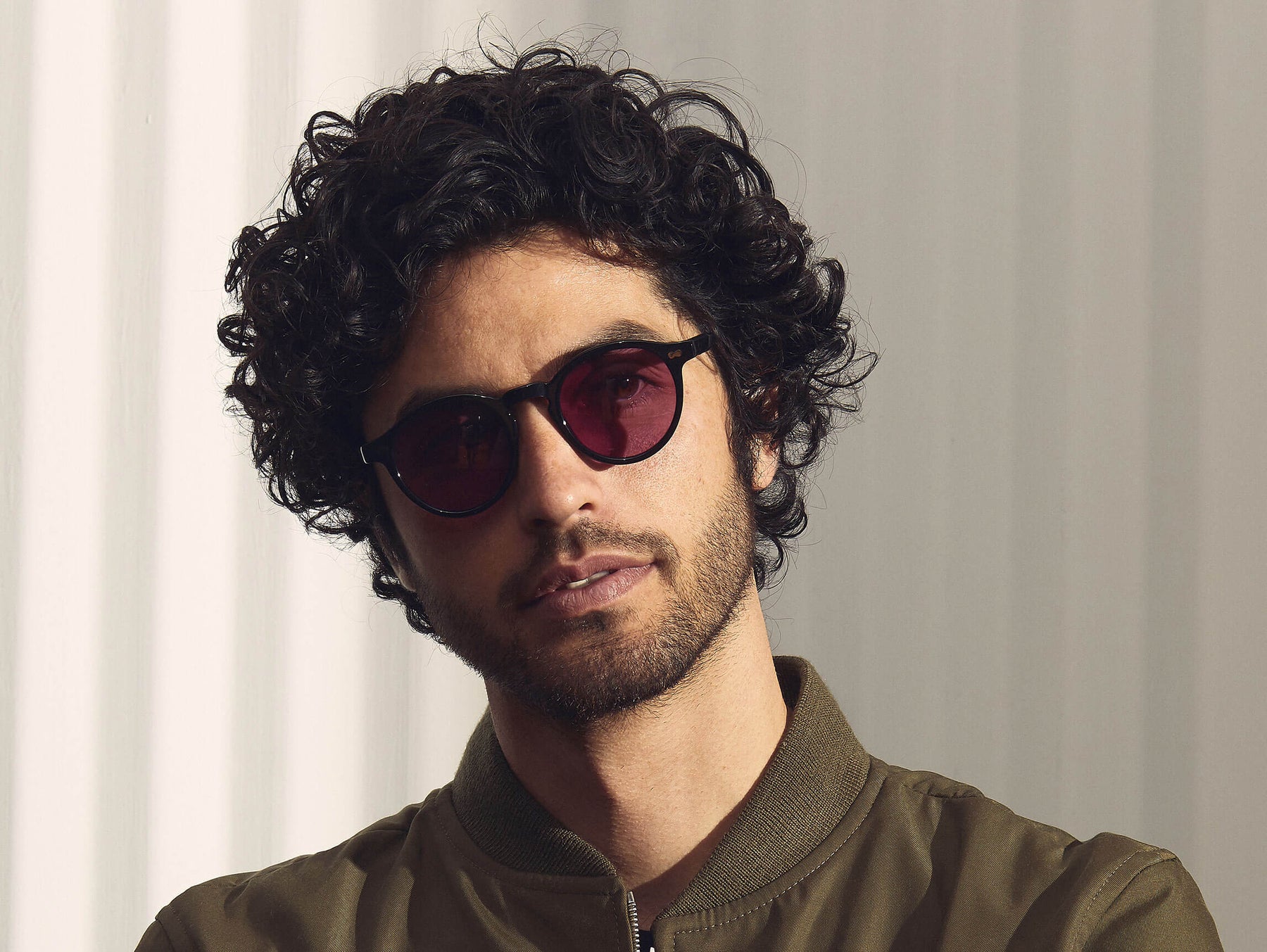 Model is wearing The MILTZEN in Black in size 49 with Purple Nurple Tinted Lenses