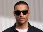 Model is wearing The MOBBLE SUN in Tortoise in size 53 with G-15 Glass Lenses