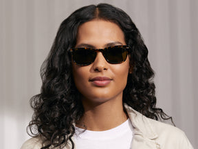 Model is wearing The MOBBLE SUN in Tortoise in size 53 with G-15 Glass Lenses
