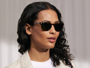 Model is wearing The MOBBLE SUN in Tortoise in size 53 with G-15 Glass Lenses