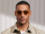 Model is wearing The LEMTOSH in Blonde in size 46 with Amber Tinted Lenses