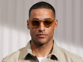 Model is wearing The LEMTOSH in Blonde in size 46 with Amber Tinted Lenses