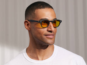 Model is wearing The LEMTOSH in Matte Black/Yellow in size 46 with Mellow Yellow Tinted Lenses