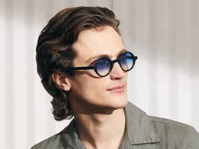 Model is wearing The ZOLMAN in Black in size 42 with Broadway Blue Fade Tinted Lenses