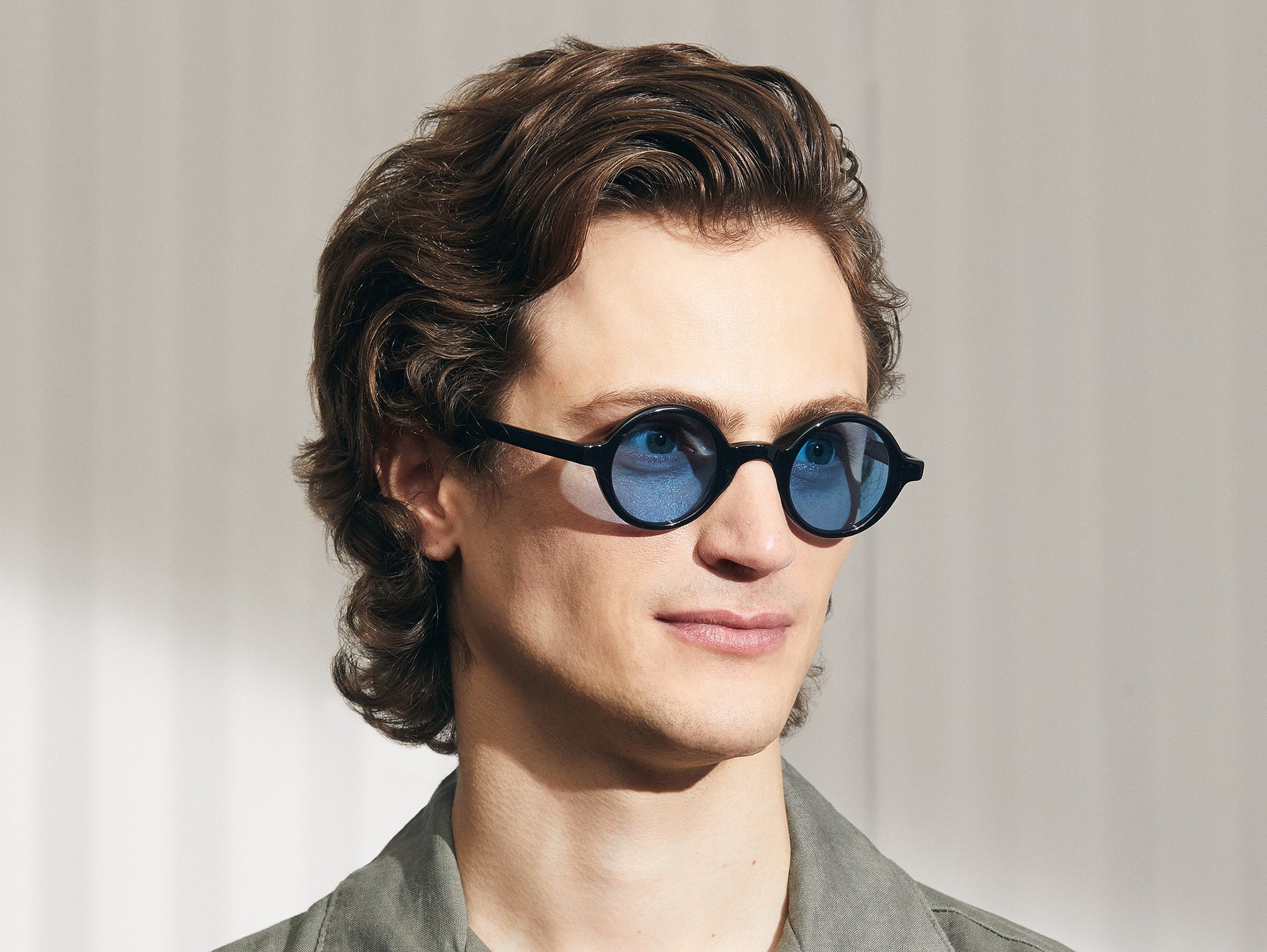 Model is wearing The ZOLMAN in Black in size 42 with Celebrity Blue Tinted Lenses