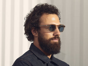 Model is wearing The MOMZA SUN in Cinnamon in size 49 with Blue Glass Lenses