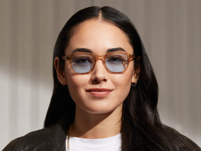 Model is wearing The MOMZA in Cinnamon in size 46 with Bel Air Blue Tinted Lenses