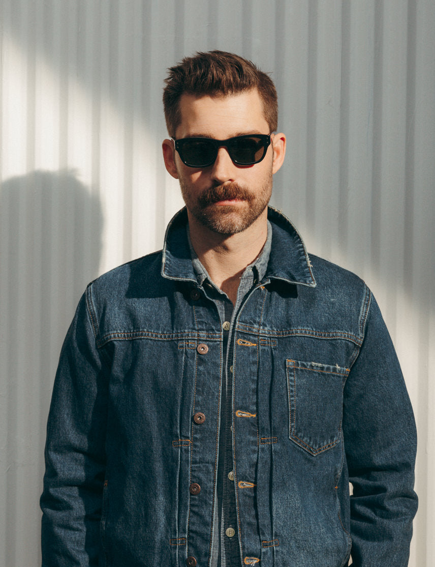 Model is wearing The NEBB SUN in Black in size 51 with G-15 Glass Lenses