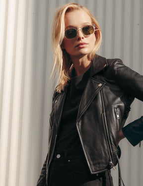 Model is wearing The NEBB SUN in Crystal in size 51 with Calibar Green Glass Lenses