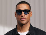 Model is wearing The NUDNIK SUN in Black in size 50 with Celebrity Tinted Lenses