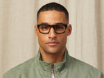 Model is wearing The NUDNIK in size 50 in Tortoise