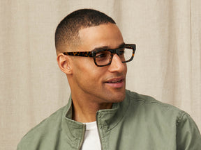 Model is wearing The NUDNIK in size 50 in Tortoise