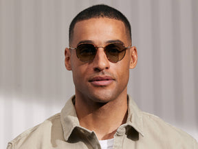 Model is wearing The PITSEL SUN in Blonde/Gold in size 47 with Forest Wood Tinted Lenses