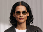 Model is wearing The PITSEL SUN in Blonde/Gold in size 47 with Forest Wood Tinted Lenses