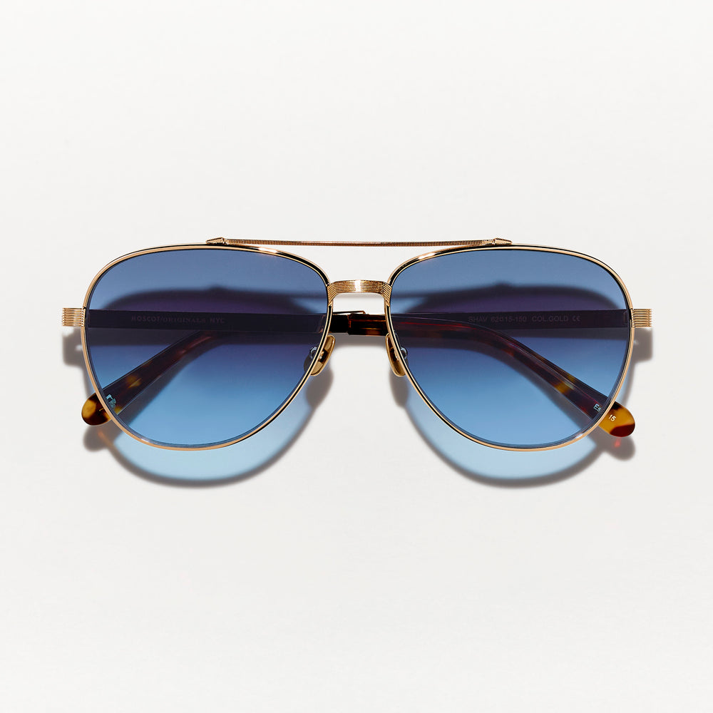 #color_gold | The SHAV SUN in Gold with Denim Blue Tinted Lenses