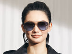 Model is wearing The SHAV SUN in Gold in size 62 with Denim Blue Tinted Lenses