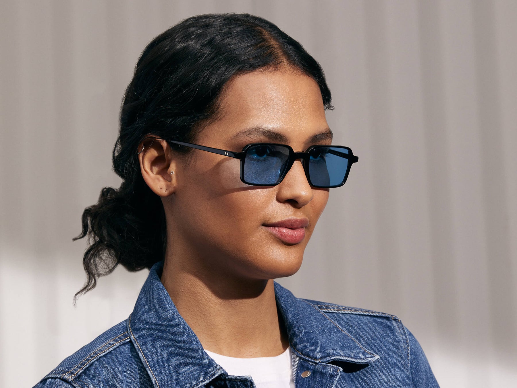 Model is wearing The SHINDIG Black in size 50 with Celebrity Blue Tinted Lenses