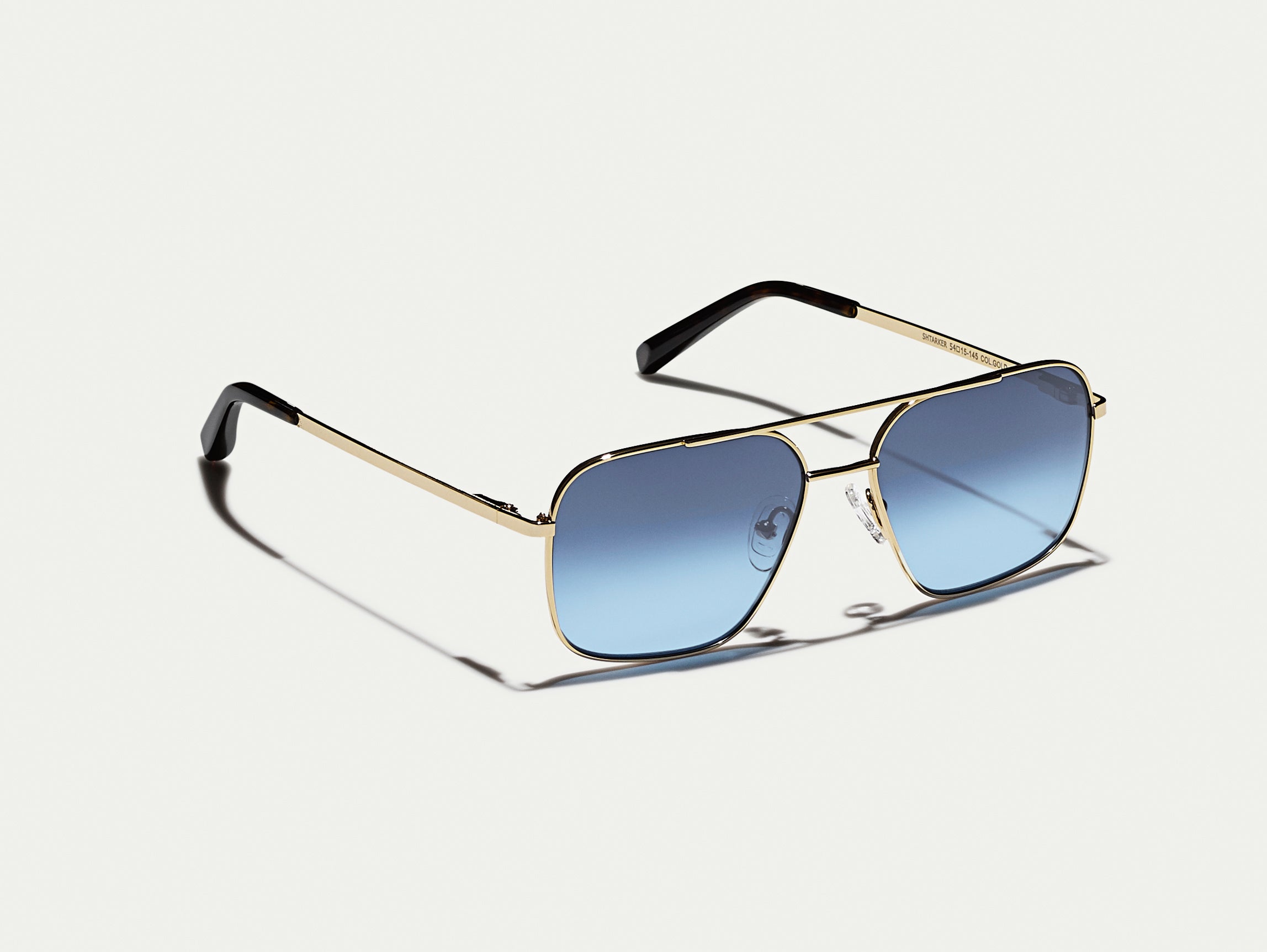 The SHTARKER in Gold with Denim Blue Tinted Lenses