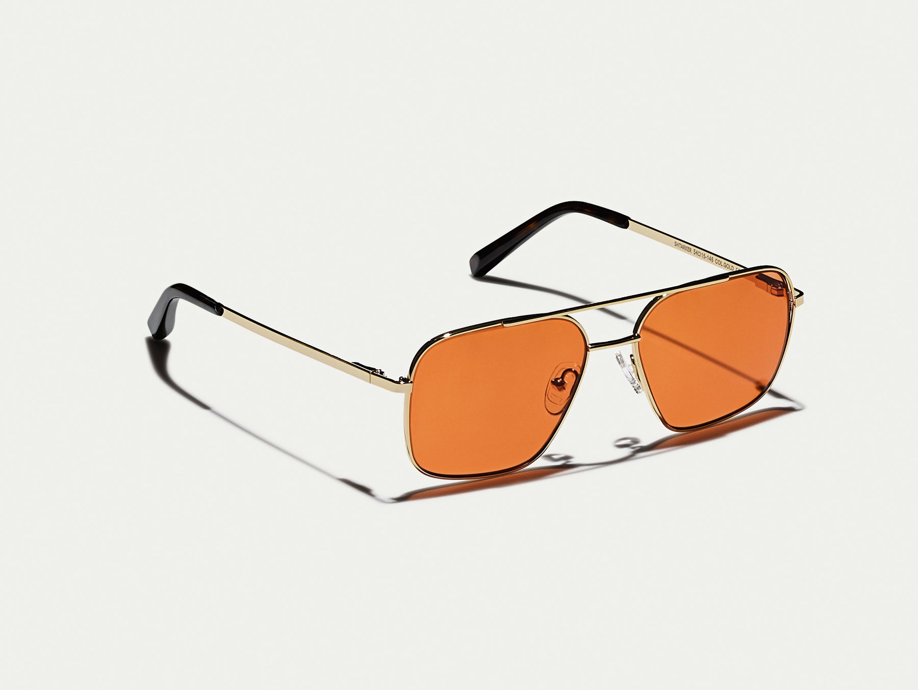 The SHTARKER in Gold with Woodstock Orange Tinted Lenses