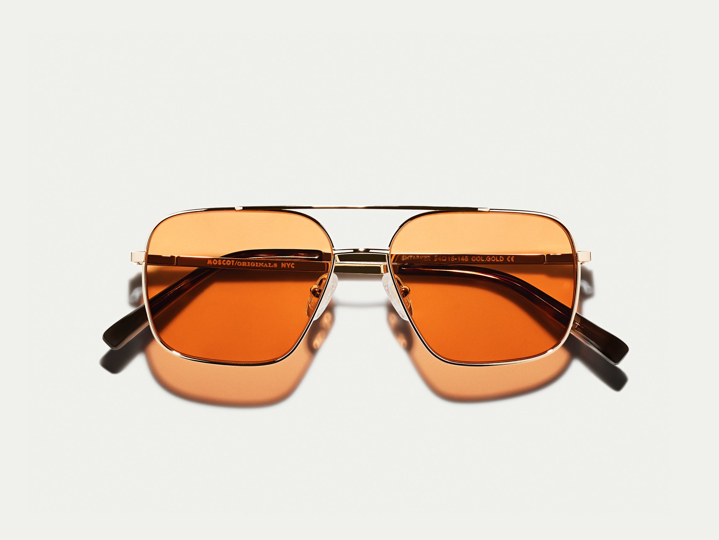 The SHTARKER in Gold with Woodstock Orange Tinted Lenses