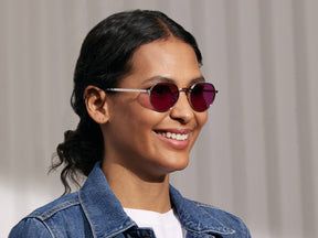 Model is wearing The SMENDRIK SUN in Silver in size 48 with Purple Nurple Tinted Lenses
